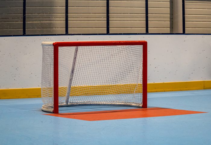 A line hockey goal, empty with no goalie in it